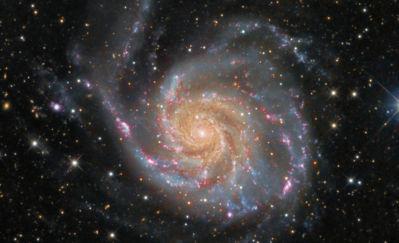 A color image of the M101 Pinwheel Galaxy, a spiral galaxy, composed of multiple exposures taken by NASA and the European Space Agency. 