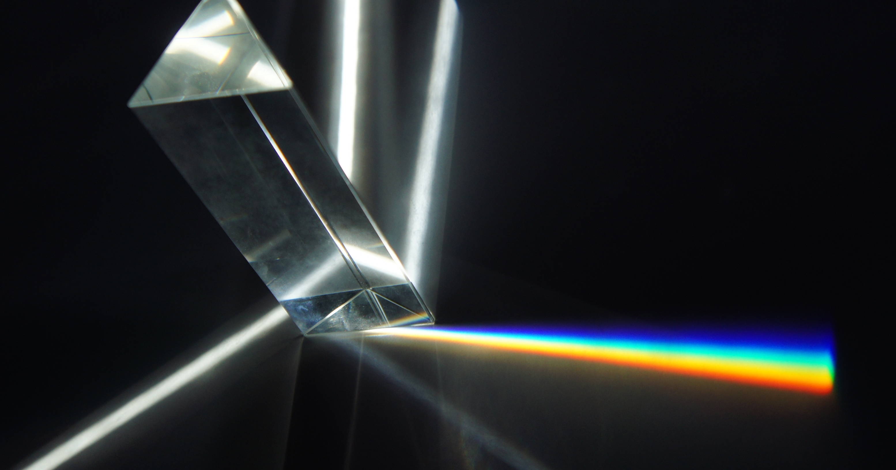 A triangular prism breaking white light into its components. 