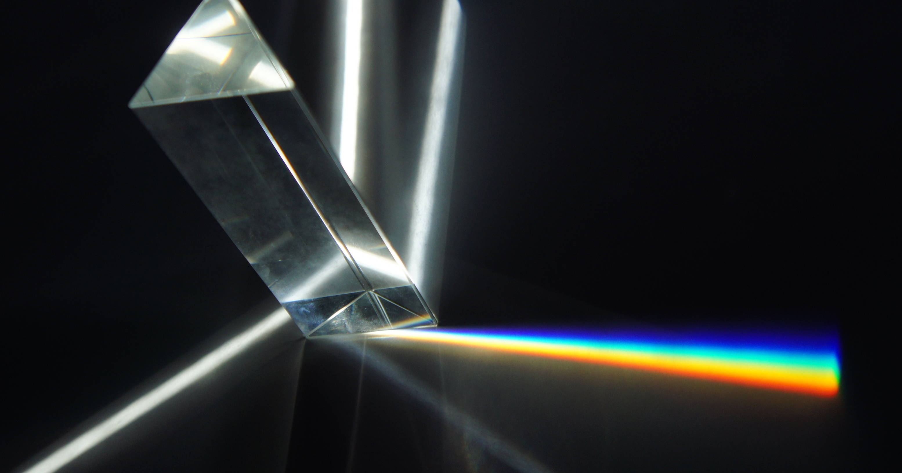 A triangular prism breaking white light into its components.