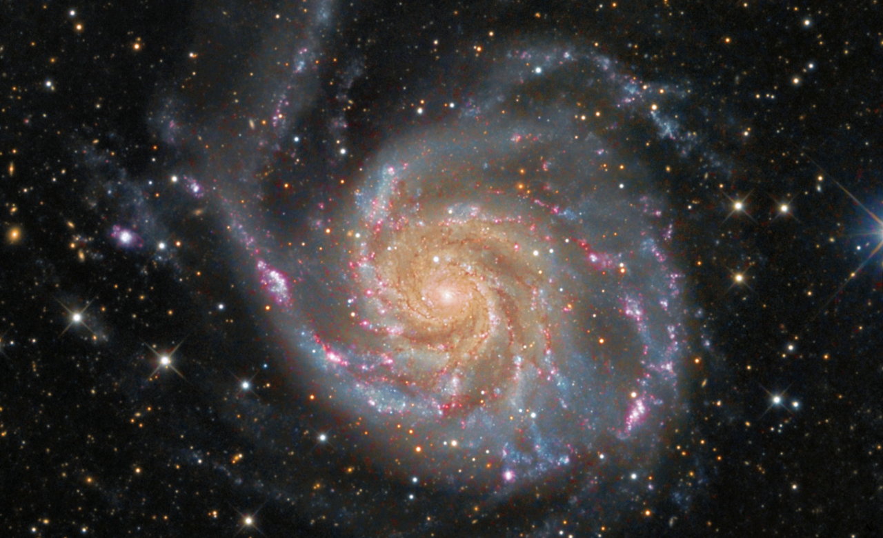 A color image of the M101 Pinwheel Galaxy, a spiral galaxy, composed of multiple exposures taken by NASA and the European Space Agency.