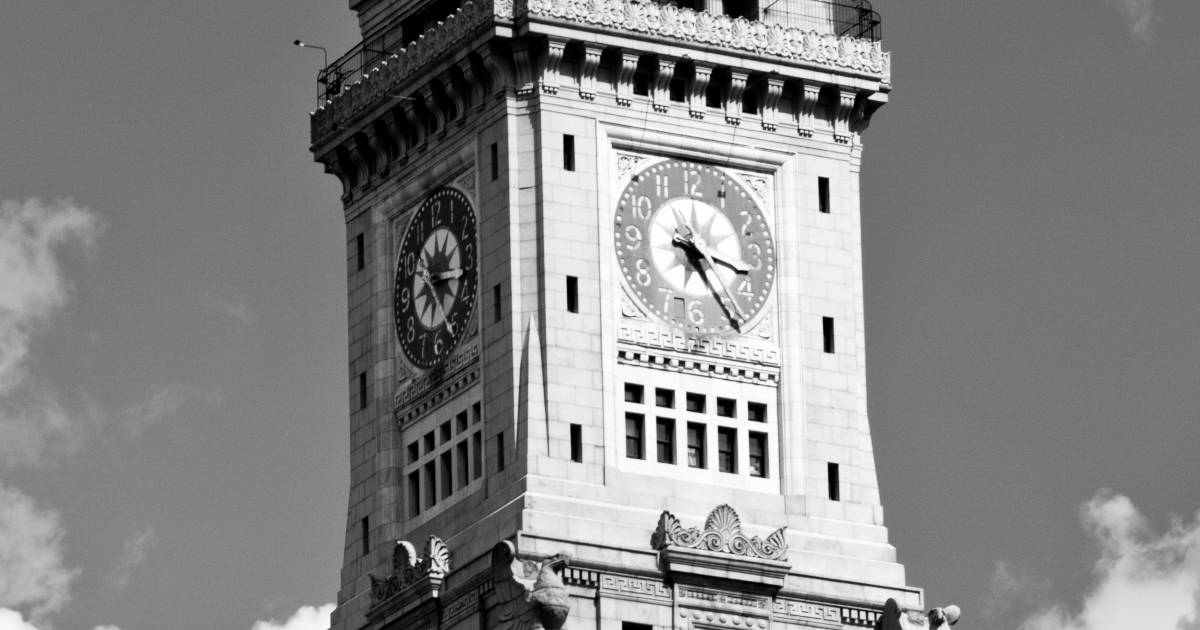 A black and white photo of the clock on the Customs House Tower in Boston. 
